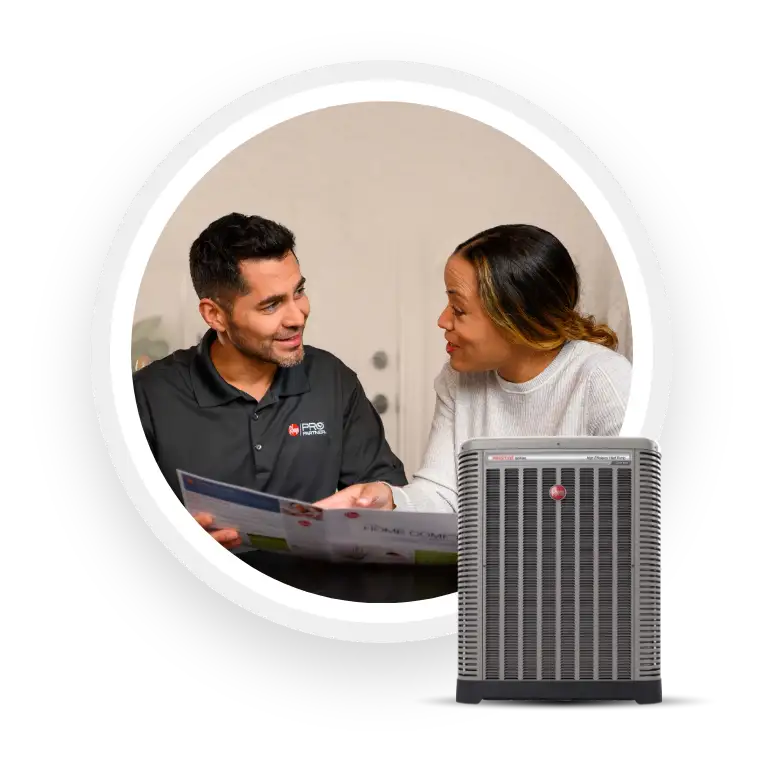 Rheem pro partner is sitting down with client, showing her the catalogue of products Rheem offers, overlap with AC unit or Heat Pump - Vandalia, IL