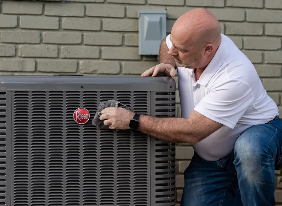 Rheem Pro partner is finishing up installation of Rheem Air Conditioner unit outside of residential home - Vandalia, IL