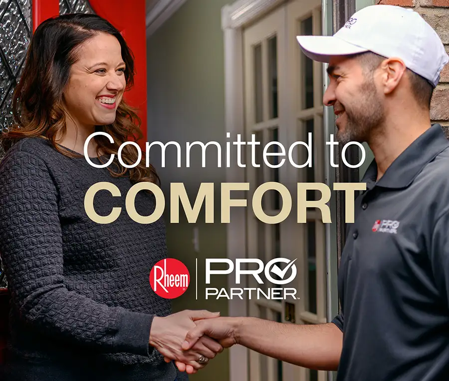 Rheem pro partner - Committed to Comfort - a happy customer shakes hands with Rheem pro technician after he serviced her AC or Heater - Vandalia, IL
