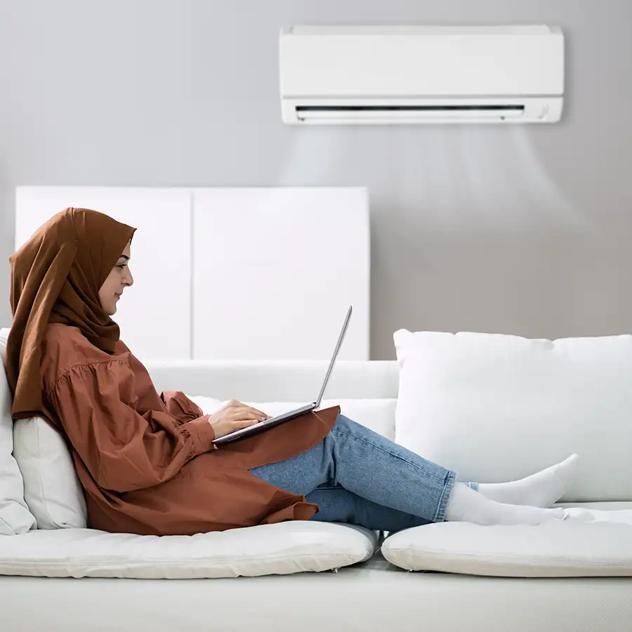 Heating and Cooling services - young Muslim woman wearing a hijab is studying, enjoying the nice cool air from her Mini Split AC - Vandalia, IL